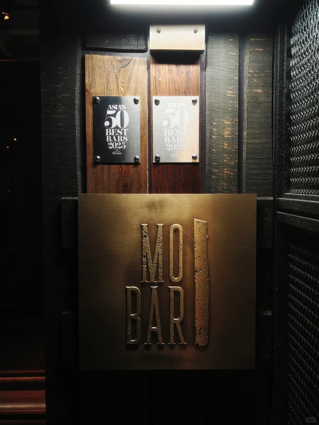The MO Bar door with its Asia's 50 Best Bars plaques