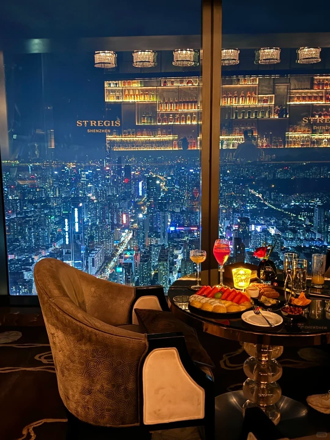 A window lounge chair over the Shenzhen skyline at the St. Regis Bar