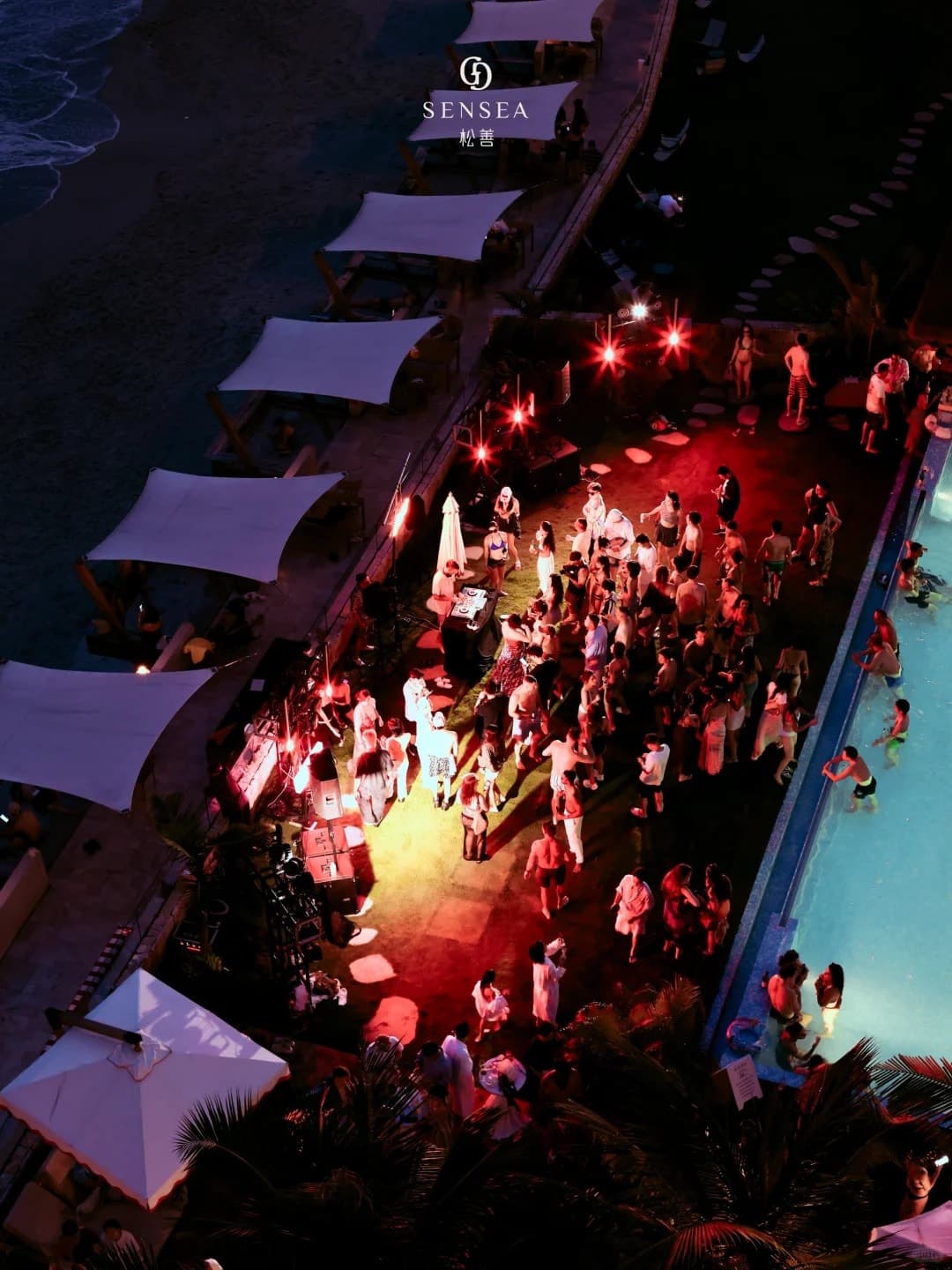 SENSEA's pool party at night, from above
