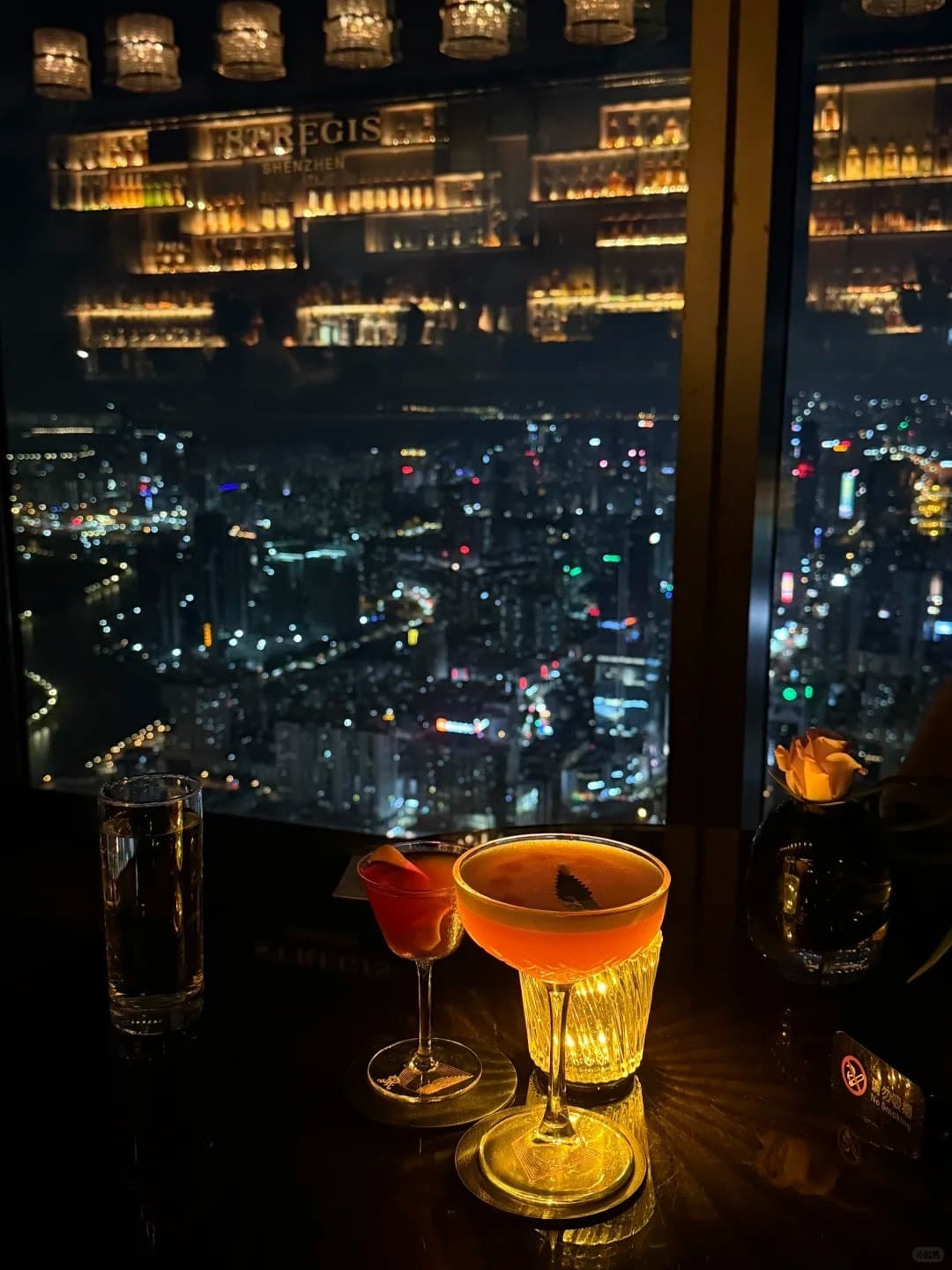 A cocktail by the window at the St. Regis Bar, 96/F