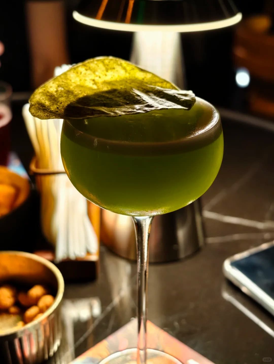 A green signature cocktail at MO Bar