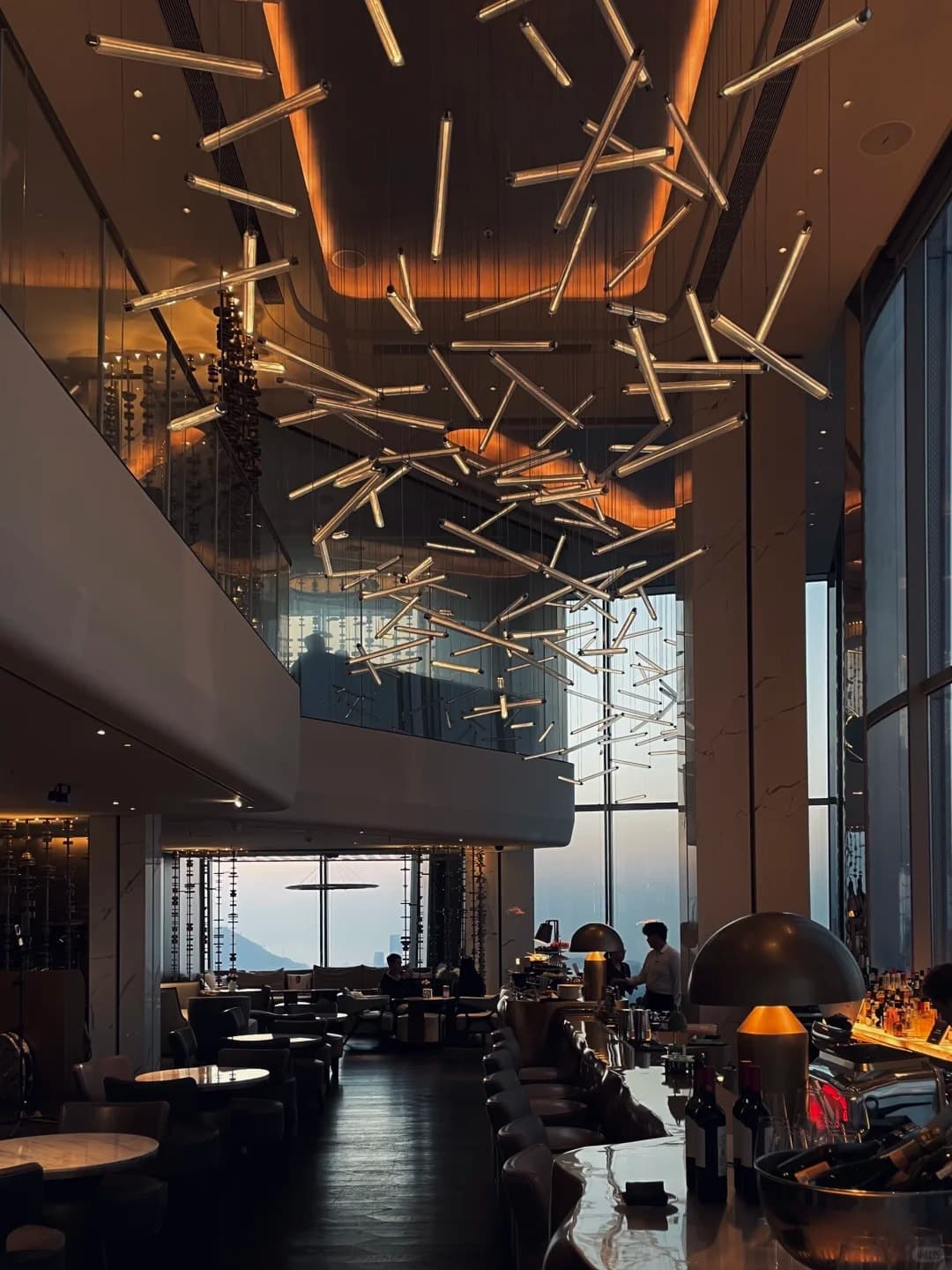 The Long Bar's ceiling installation and the double-height room at Raffles Shenzhen