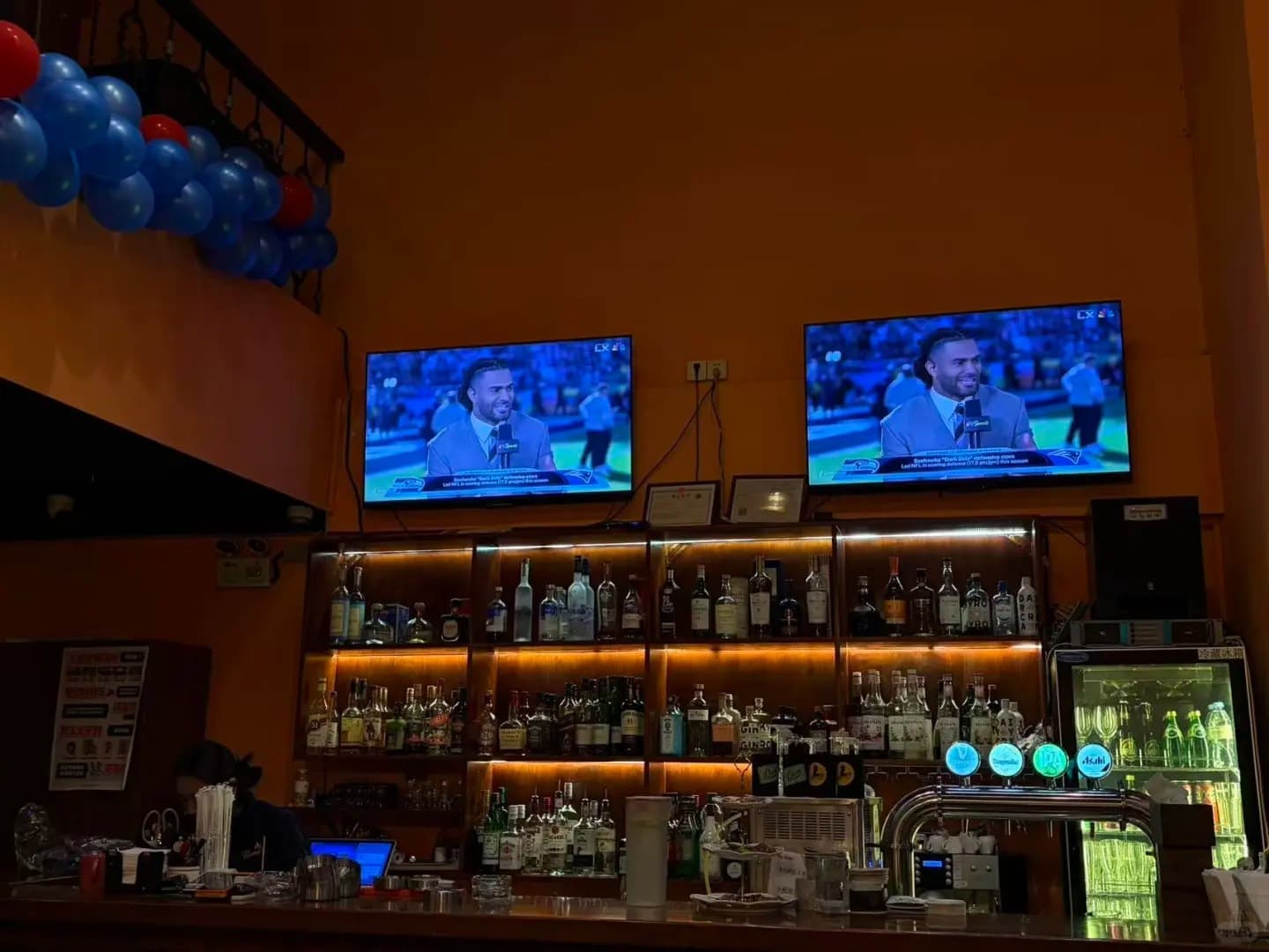 The bar and screens inside The Flames, Sea World