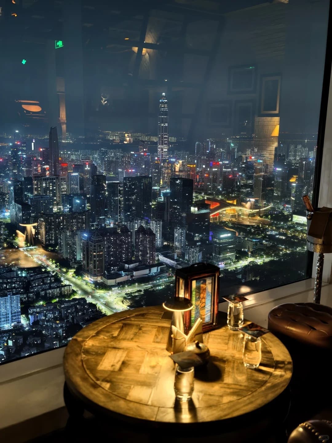 Candle-lit table by MO Bar's window, Ping An Finance Centre in view
