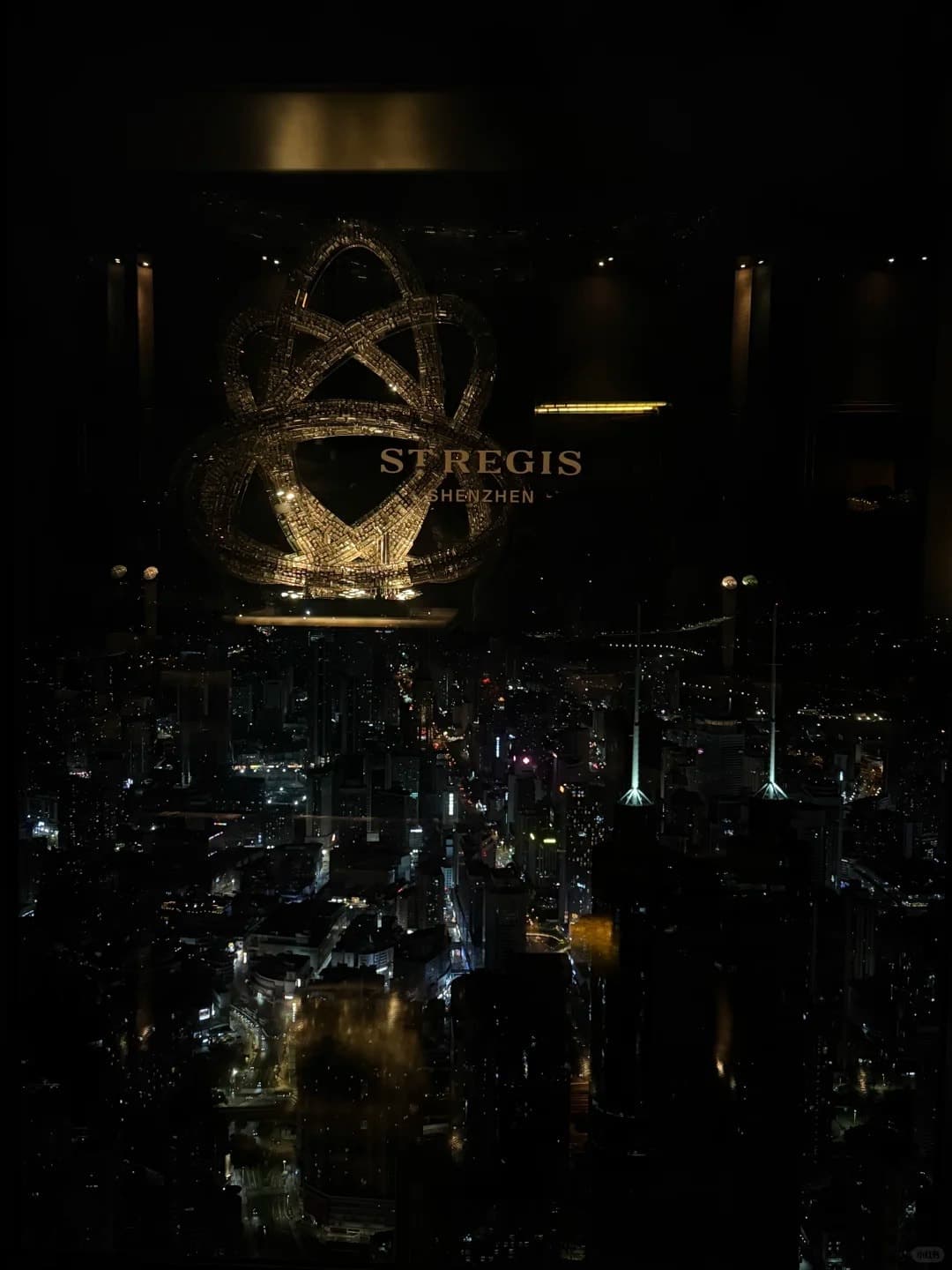 The St. Regis crest above the city at night