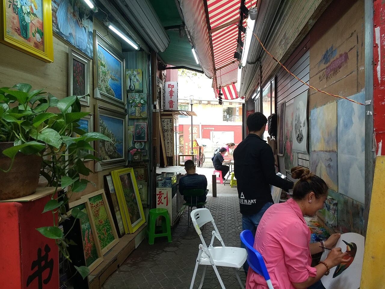 Artists at work among the studios of Dafen Oil Painting Village