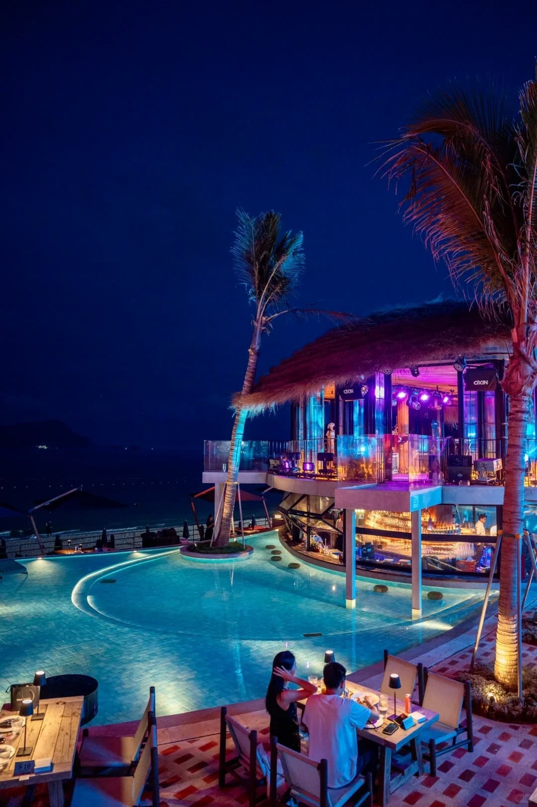 The pool and palms at Sanyea Endless Shore at blue hour